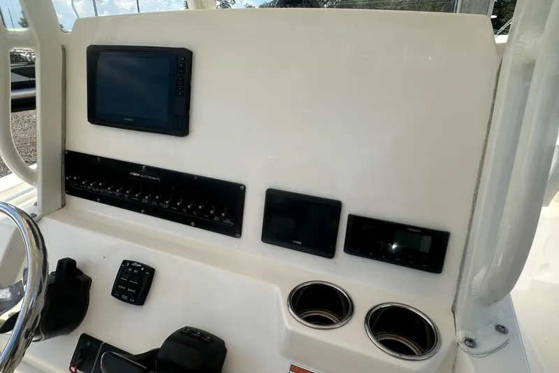 Slide: The Image of 2023 Cobia 262 Center Console dashboard with navigation screens and controls. - 25