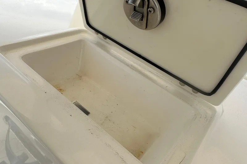 Slide: The Image of Open storage compartment on 2023 Cobia 262 Center Console boat. - 28