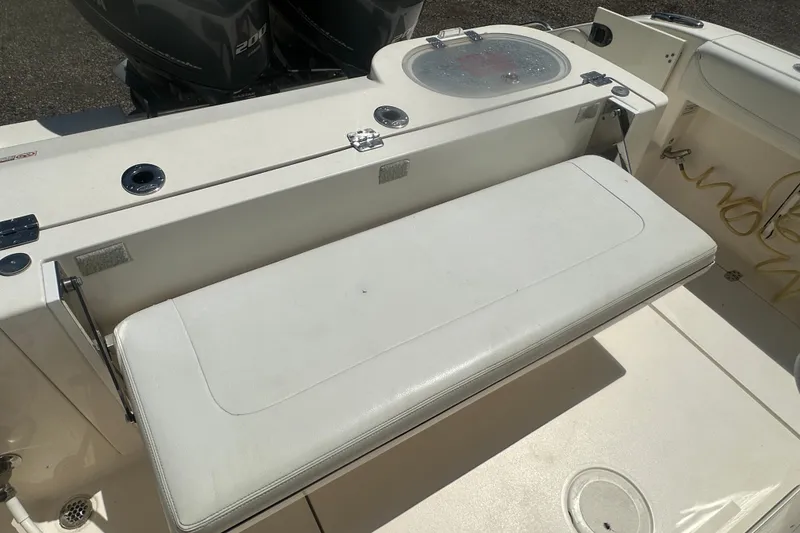 Slide: The Image of 2023 Cobia 262 Center Console boat with foldable seating and dual engines. - 31