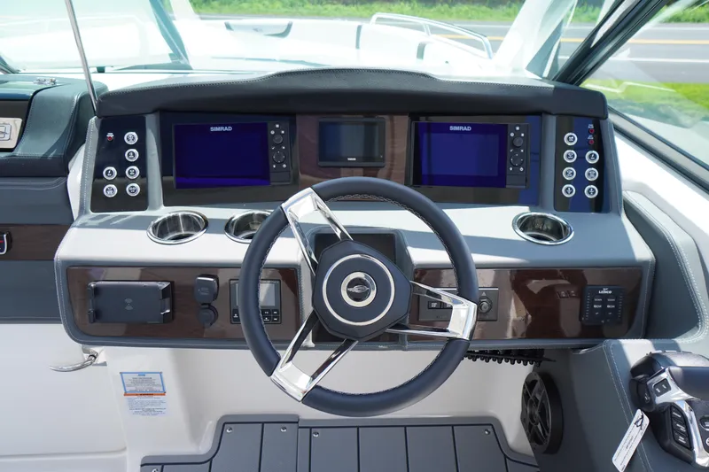 Slide: The Image of 2025 Chaparral 280 OSX boat dashboard with modern controls and dual Simrad displays. - 24
