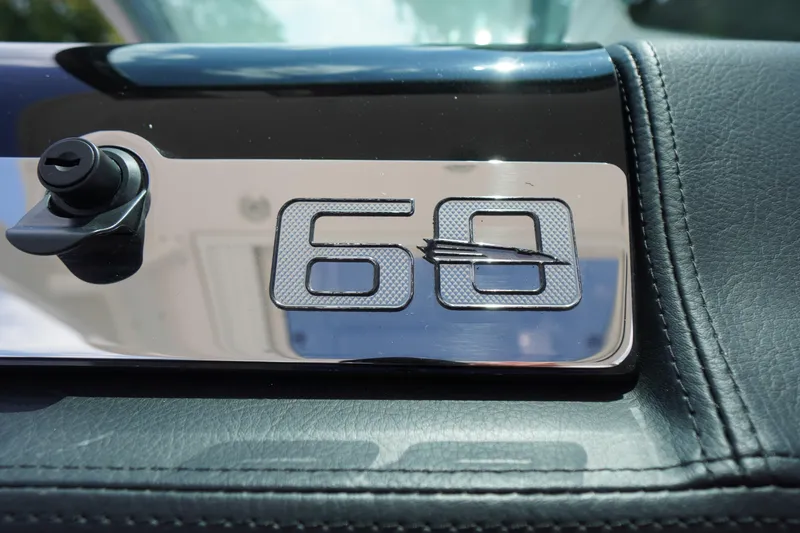 Slide: The Image of 2025 Chaparral 280 OSX emblem on leather interior, featuring '60' design. - 30