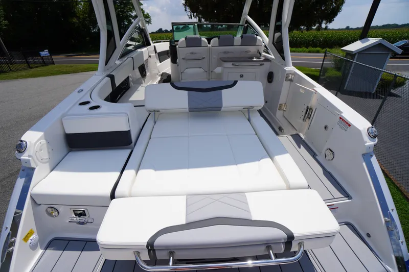 Slide: The Image of 2025 Chaparral 280 OSX boat interior with white seating and modern design. - 43