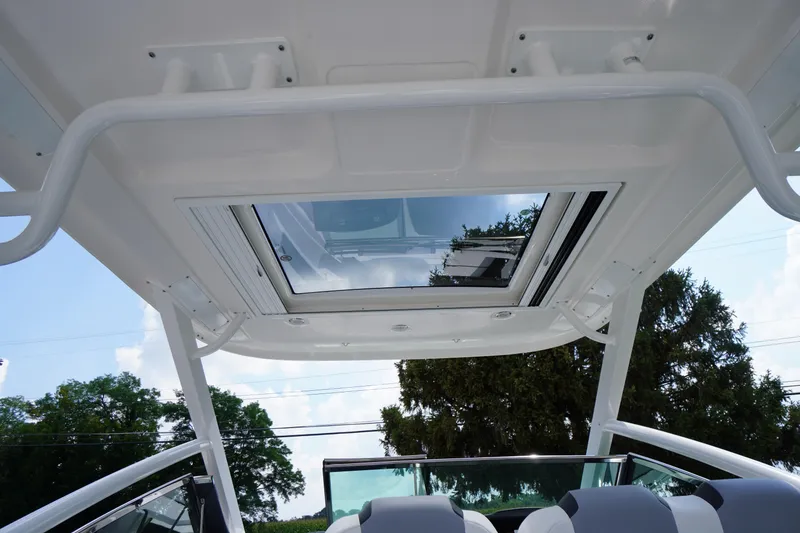 Slide: The Image of 2025 Chaparral 280 OSX boat with open sunroof and sleek interior design. - 46