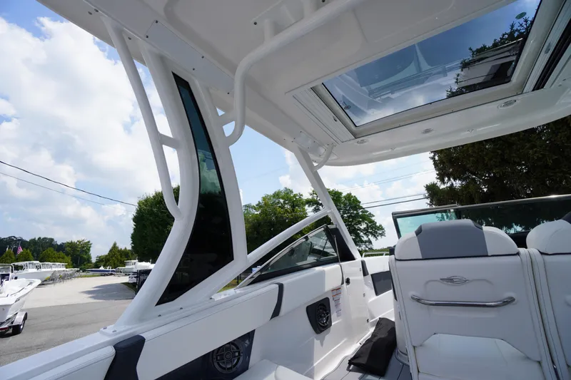 Slide: The Image of 2025 Chaparral 280 OSX boat interior with sleek design and spacious seating. - 48