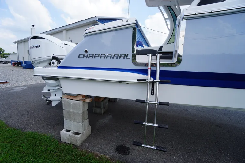 Slide: The Image of 2025 Chaparral 280 OSX boat with Yamaha engine, docked on concrete blocks. - 50