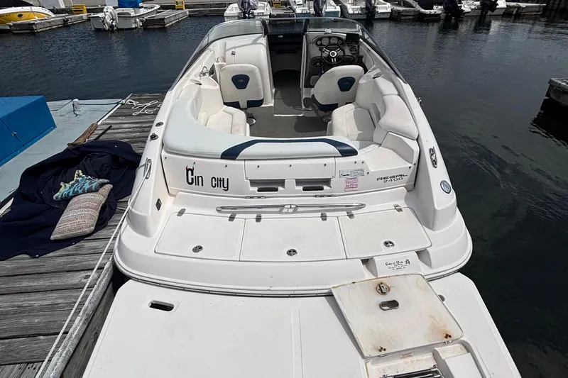Slide: The Image of 2007 Regal 2400 Bowrider boat docked, featuring spacious seating and sleek design. - 3
