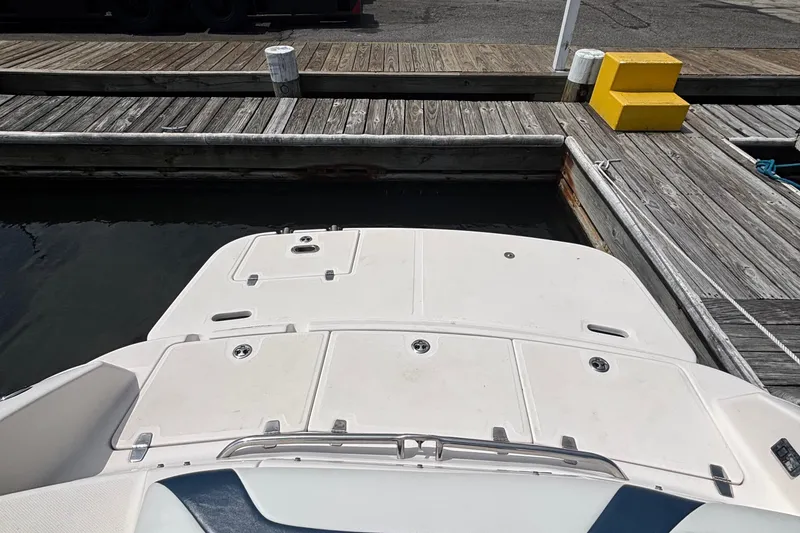 Slide: The Image of 2007 Regal 2400 Bowrider boat docked at a wooden pier. - 4