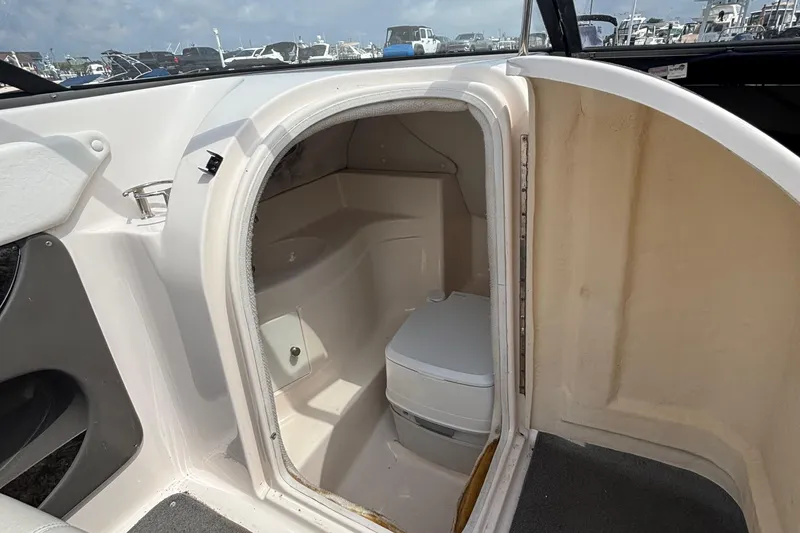 Slide: The Image of 2007 Regal 2400 Bowrider boat interior with compact marine toilet. - 7