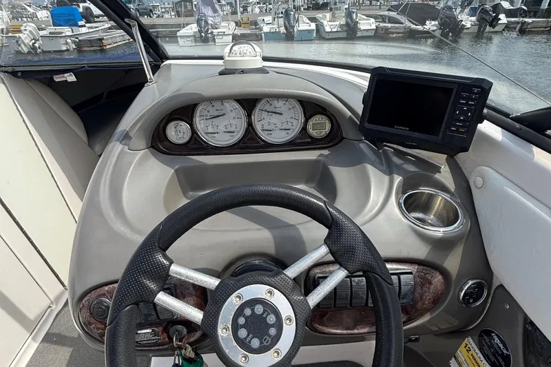 Slide: The Image of 2007 Regal 2400 Bowrider dashboard with steering wheel, gauges, and navigation system. - 8
