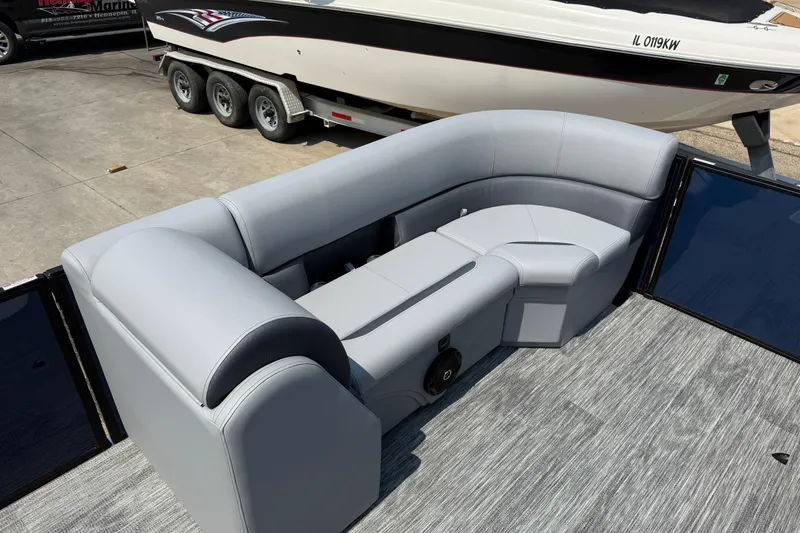 Slide: The Image of 2026 Bentley Pontoons Legacy 223 Swingback with luxurious gray seating on a boat deck. - 11