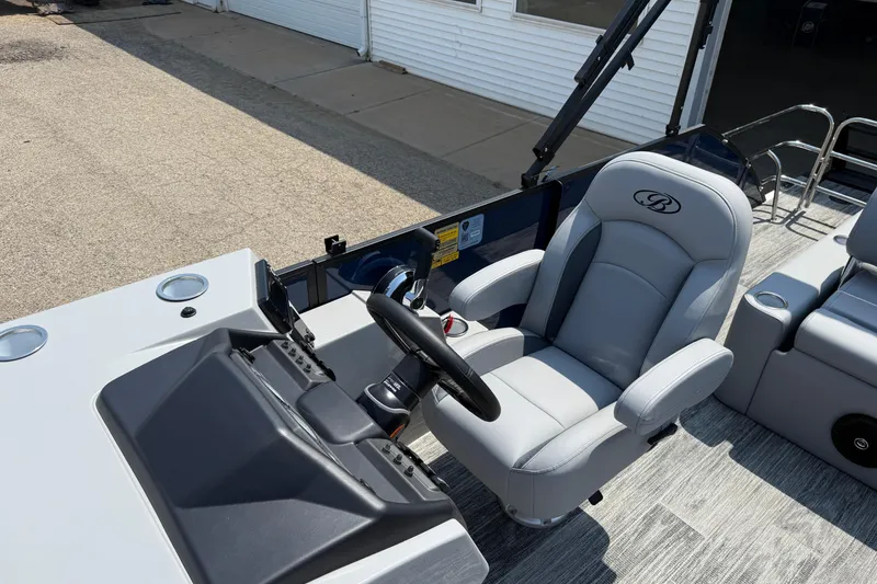 Slide: The Image of 2026 Bentley Pontoons Legacy 223 Swingback helm with luxurious captain's chair and modern controls. - 16