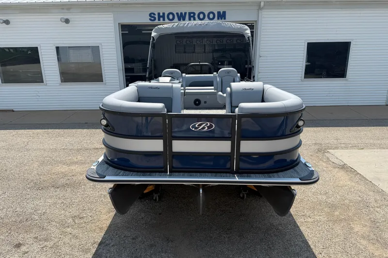 Slide: The Image of 2026 Bentley Pontoons Legacy 223 Swingback in front of a showroom. - 2