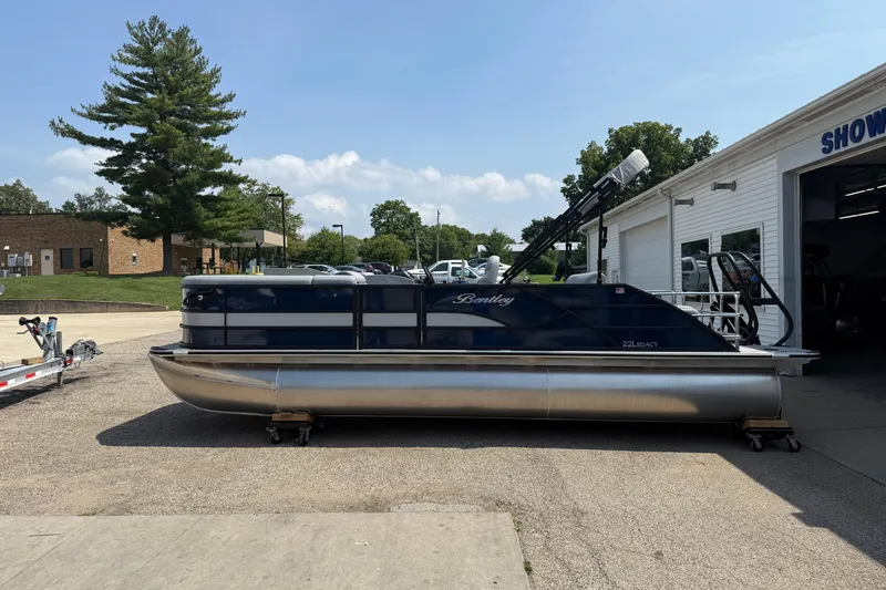 Slide: The Image of 2026 Bentley Pontoons Legacy 223 Swingback pontoon boat parked outside showroom. - 4