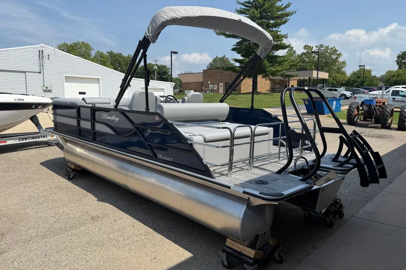 Slide: The Image of 2026 Bentley Pontoons Legacy 223 Swingback, sleek design, parked outdoors under clear sky. - 5