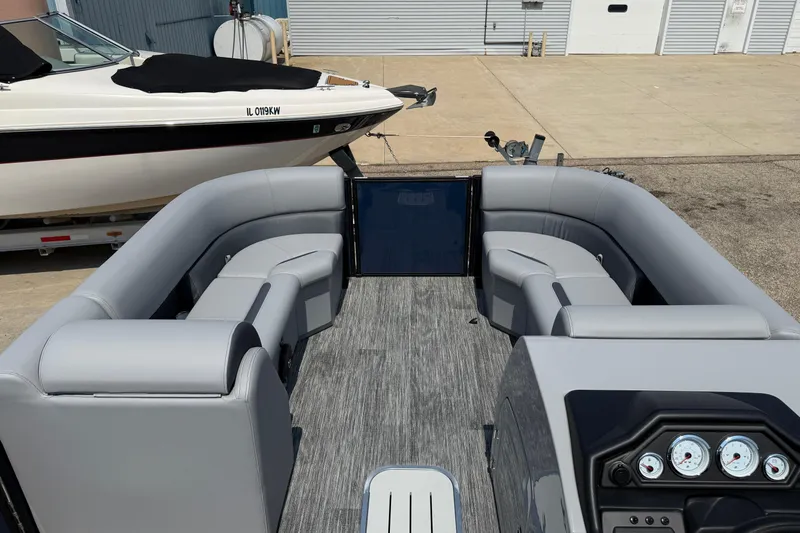 Slide: The Image of 2026 Bentley Pontoons Legacy 223 Swingback interior with gray seating and dashboard. - 7