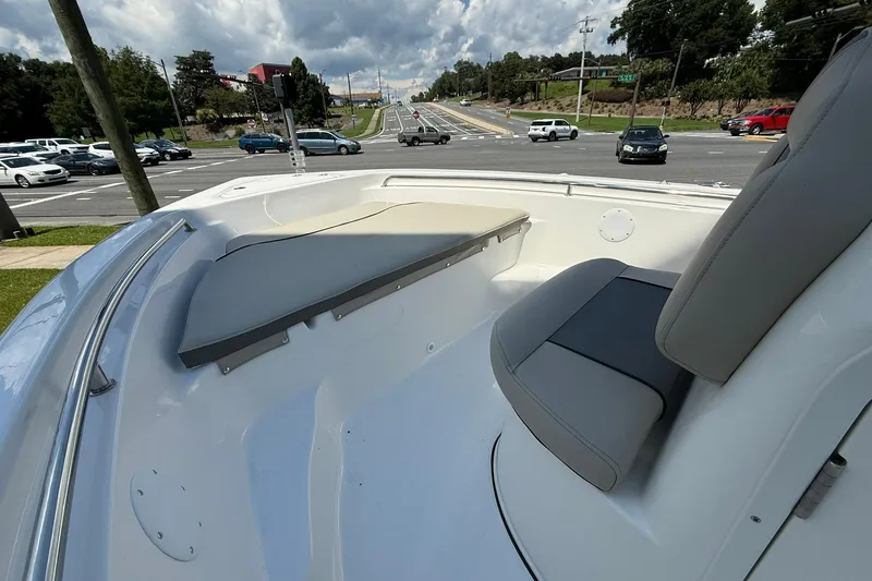 Slide: The Image of 2025 Key West 189 FS boat interior with seating, parked near a busy road. - 5