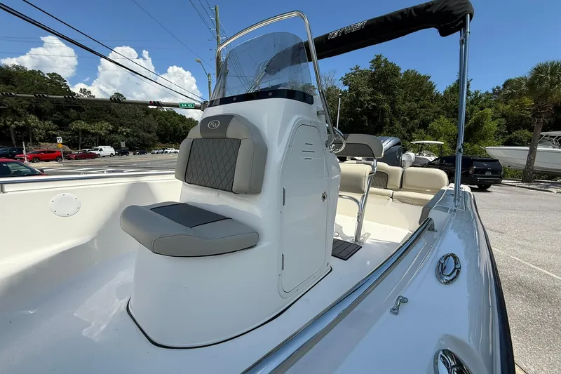 Slide: The Image of 2025 Key West 189 FS boat with seating and console, parked outdoors. - 6