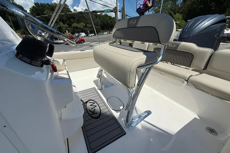 Slide: The Image of 2025 Key West 189 FS boat interior with cushioned seating and steering console. - 8
