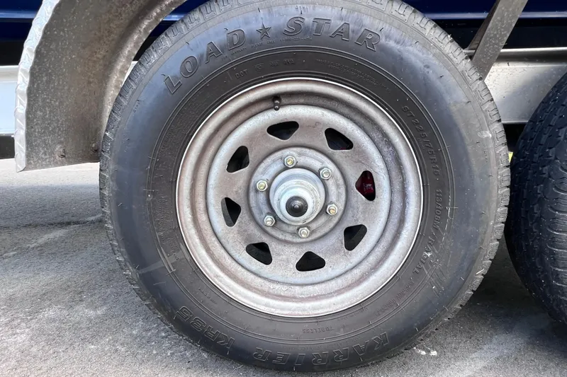 Slide: The Image of Trailer wheel with Loadstar tire on a 2017 Contender 24 Sport boat trailer. - 12