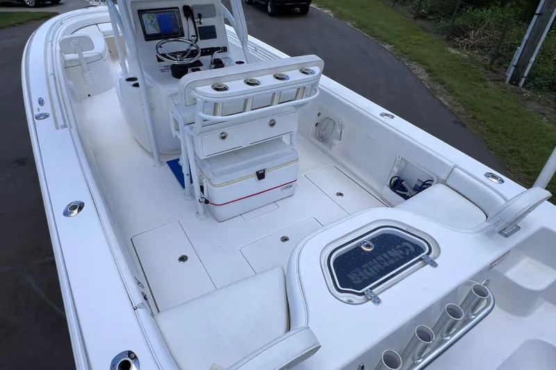 Slide: The Image of 2017 Contender 24 Sport boat interior with console, seating, and storage compartments. - 15