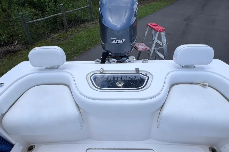 Slide: The Image of 2017 Contender 24 Sport boat with Yamaha 300 engine, white seating, and livewell. - 17