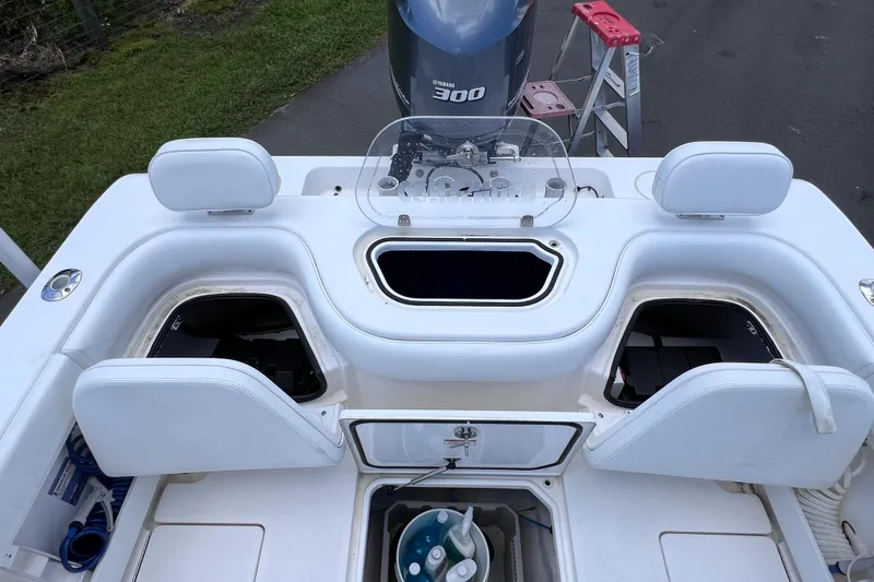 Slide: The Image of 2017 Contender 24 Sport boat interior with storage compartments and Yamaha 300 engine. - 18