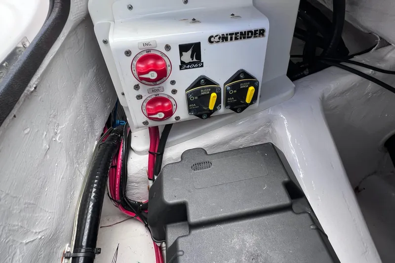 Slide: The Image of Control panel of a 2017 Contender 24 Sport boat with switches and wiring. - 19