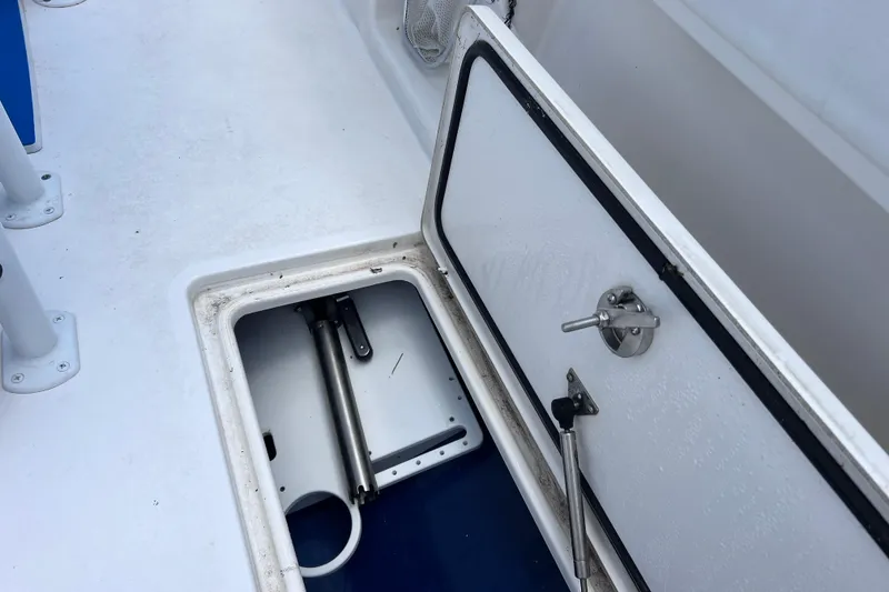Slide: The Image of Open storage compartment on 2017 Contender 24 Sport boat deck. - 22