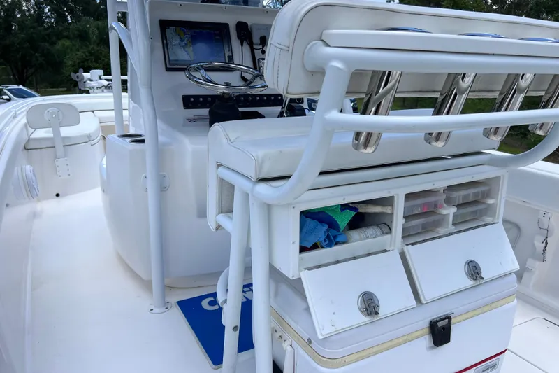 Slide: The Image of 2017 Contender 24 Sport boat interior with storage compartments and navigation equipment. - 25