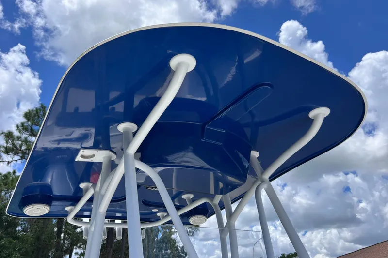 Slide: The Image of 2017 Contender 24 Sport boat T-top against a cloudy blue sky. - 28