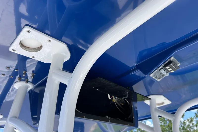 Slide: The Image of 2017 Contender 24 Sport boat T-top with blue finish and mounted electronics. - 29