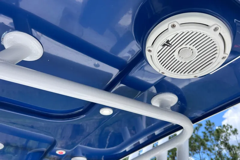 Slide: The Image of 2017 Contender 24 Sport boat with blue canopy and mounted speaker. - 30