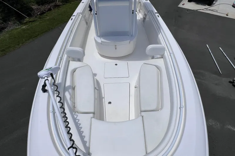 Slide: The Image of 2017 Contender 24 Sport boat interior with seating and trolling motor. - 34