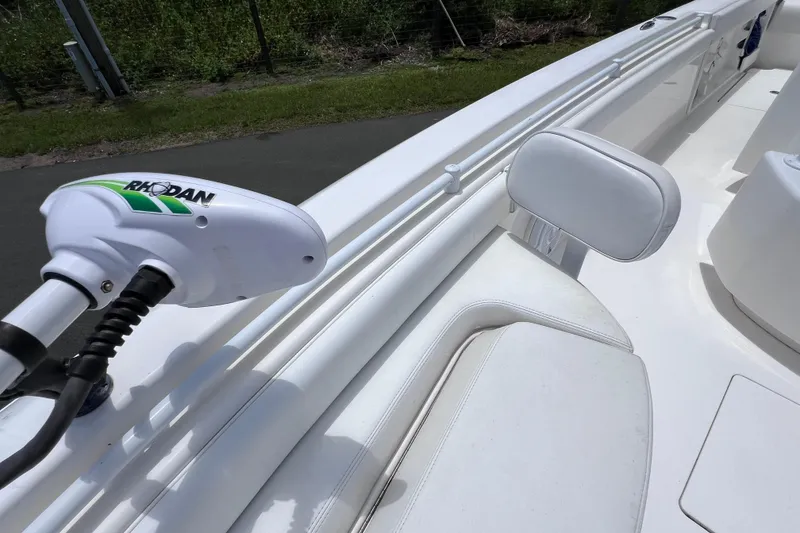 Slide: The Image of 2017 Contender 24 Sport boat interior with Rhodan trolling motor, white seating, and rod holders. - 35