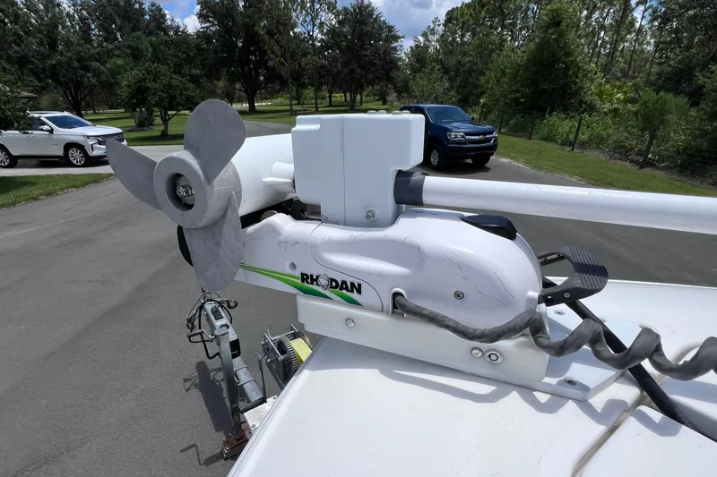 Slide: The Image of 2017 Contender 24 Sport with Rhodan trolling motor on a trailer in a driveway. - 37