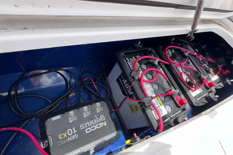 Slide: The Image of Battery compartment of a 2017 Contender 24 Sport boat with NOCO Genius charger. - 38