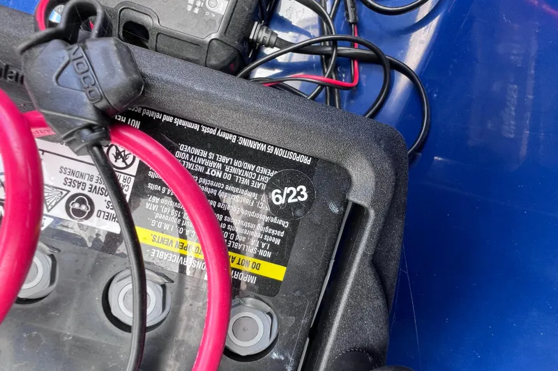 Slide: The Image of Battery with red and black cables in a 2017 Contender 24 Sport boat. - 39