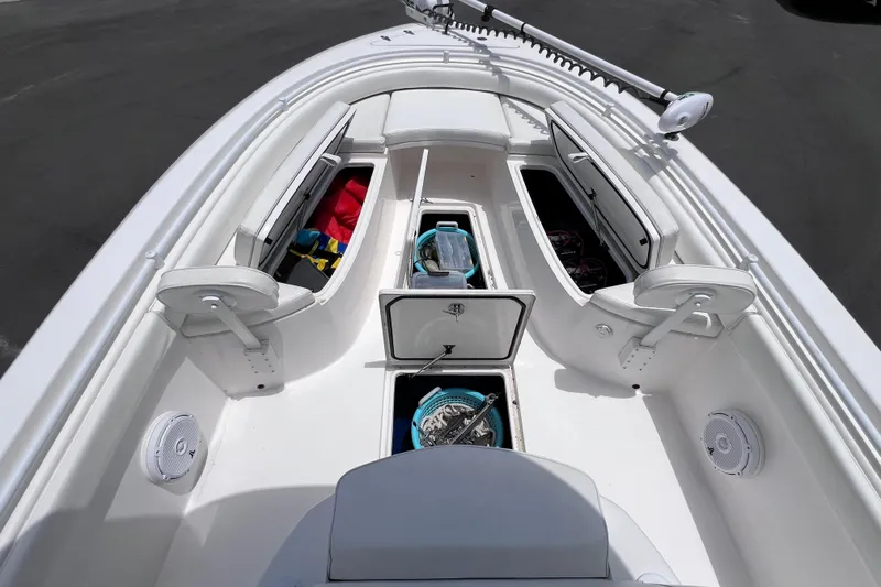 Slide: The Image of 2017 Contender 24 Sport boat interior with open storage compartments and fishing gear. - 40