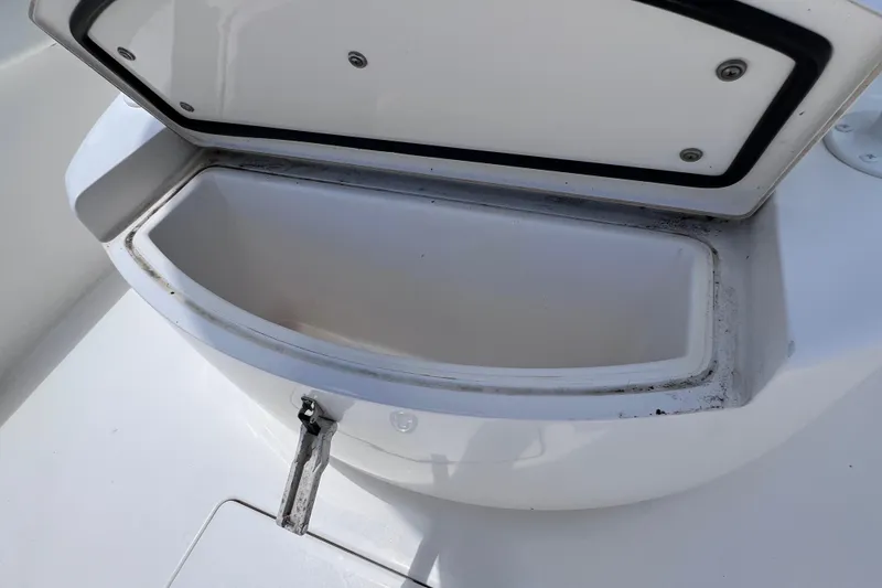 Slide: The Image of Open storage compartment on 2017 Contender 24 Sport boat. - 42