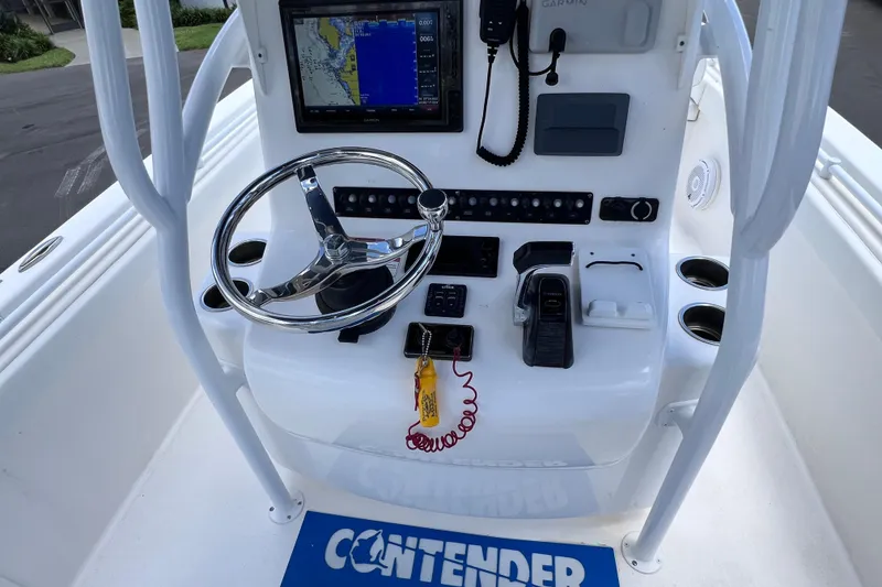 Slide: The Image of 2017 Contender 24 Sport boat console with steering wheel and navigation system. - 48