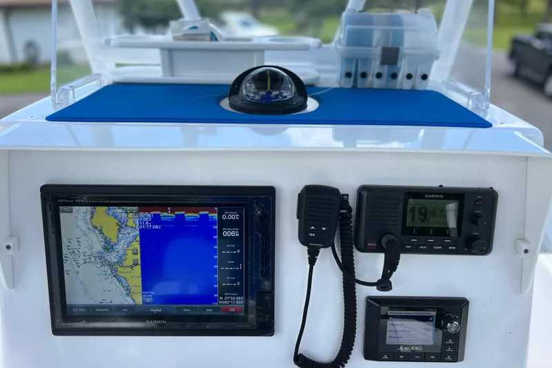 Slide: The Image of Control panel of a 2017 Contender 24 Sport boat with navigation and communication equipment. - 49