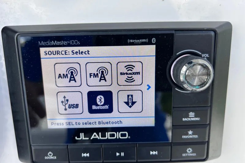 Slide: The Image of JL Audio MediaMaster 100s display on 2017 Contender 24 Sport, showing audio source options. - 50