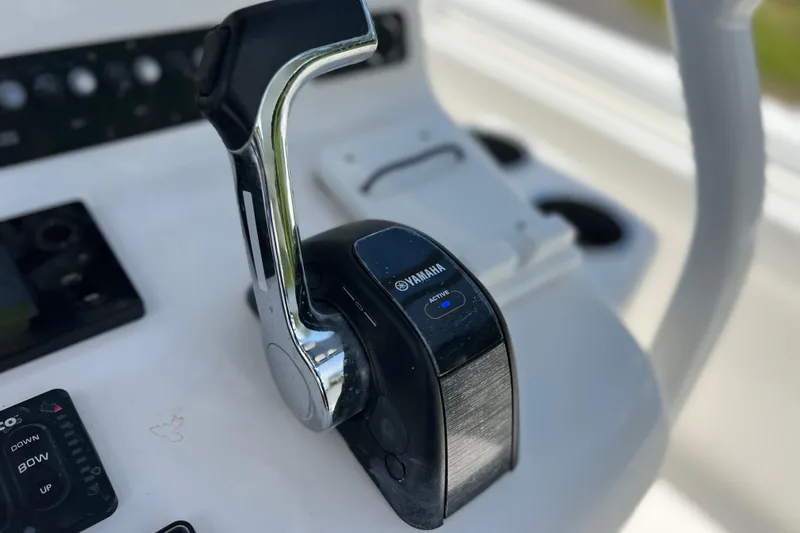 Slide: The Image of Yamaha throttle control on 2017 Contender 24 Sport boat dashboard. - 53