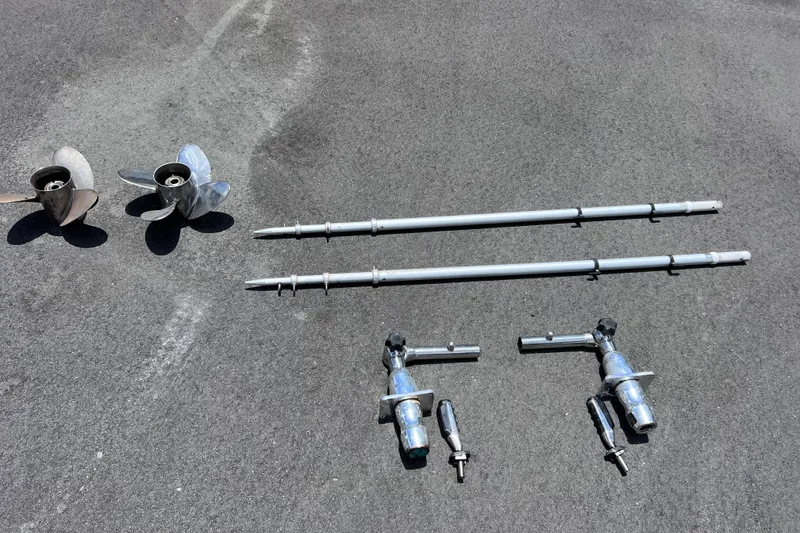 Slide: The Image of Boat parts including propellers and poles for 2017 Contender 24 Sport on asphalt surface. - 55