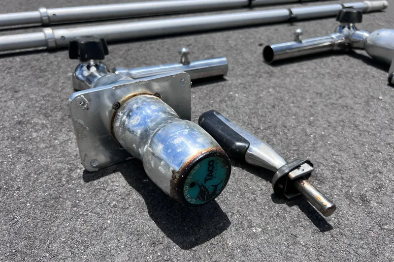 Slide: The Image of Boat hardware components on asphalt, including metal rods and fittings, for 2017 Contender 24 Sport. - 56