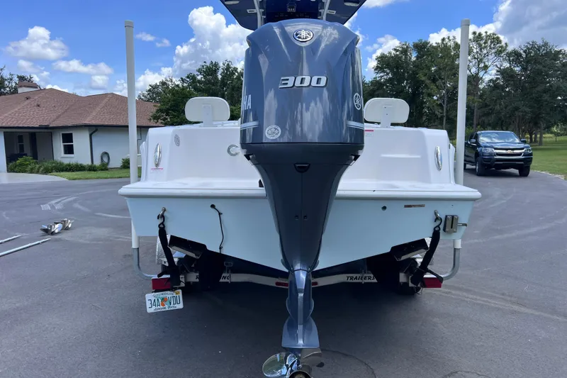 Slide: The Image of 2017 Contender 24 Sport boat with Yamaha 300 engine, parked on a driveway. - 6