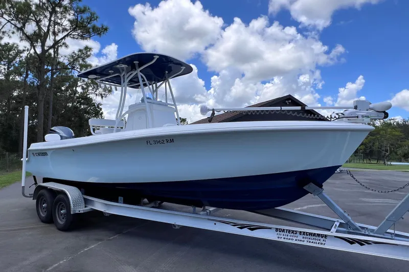 Slide: The Image of 2017 Contender 24 Sport boat on trailer under a cloudy sky. - 9