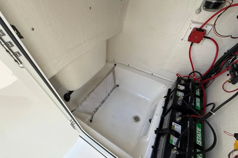 Slide: The Image of Interior view of a 2026 Key West 239 FS boat showing battery compartment and wiring. - 5