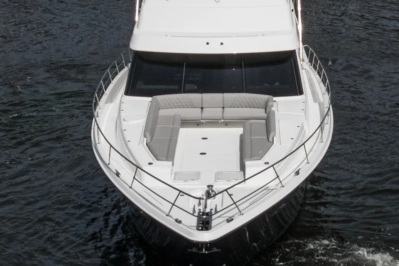 Slide: The Image of 2023 Riviera 64 Sports Motor Yacht deck with seating and tender boat. - 10