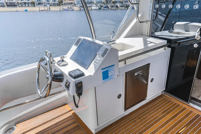 Slide: The Image of Luxurious interior of 2023 Riviera 64 Sports Motor Yacht with elegant seating and dining area. - 15